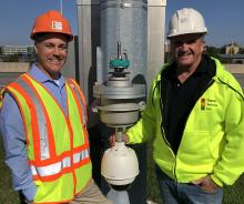 Ryan Brown, president, Signal Service, (left), and Steve Dowdall, ITS director, Signal Service with the MG2 CAT6a Ethernet Camera Lowering Device and a Bosch Starlight IP camera