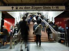 Walking up stairs in train station 